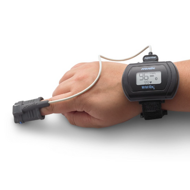 Person wearing the Nonin 3150 BLE WristOx2 on their wrist, with the soft sensor applied to their finger for SpO2 monitoring.