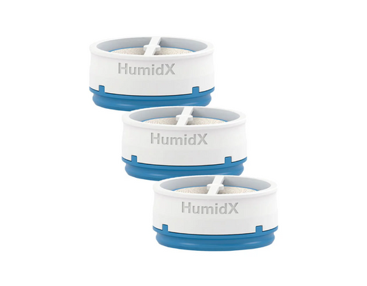A digital image showing three ResMed HumidX waterless humidification capsules stacked diagonally, designed for use with the AirMini CPAP machine.